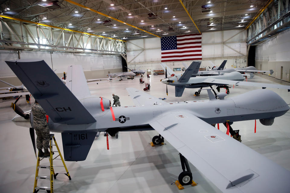 MQ-9 Reapers and an MQ-1B Predator remotely piloted aircraft (RPA) are parked in a hanger at Creech Air Force Base on November 17, 2015 in Indian Springs, Nevada.  (Isaac Brekken/Getty Images)