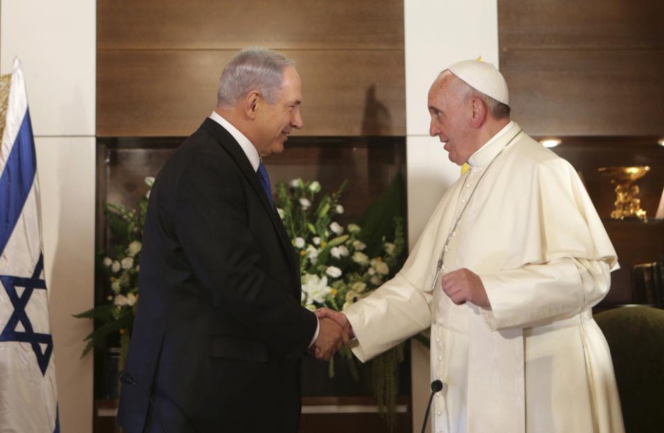 Pope Francis shakes hands with Israel's Prime Minister Benjamin Netanyahu during their meeting at the Notre Dame Center in Jerusalem