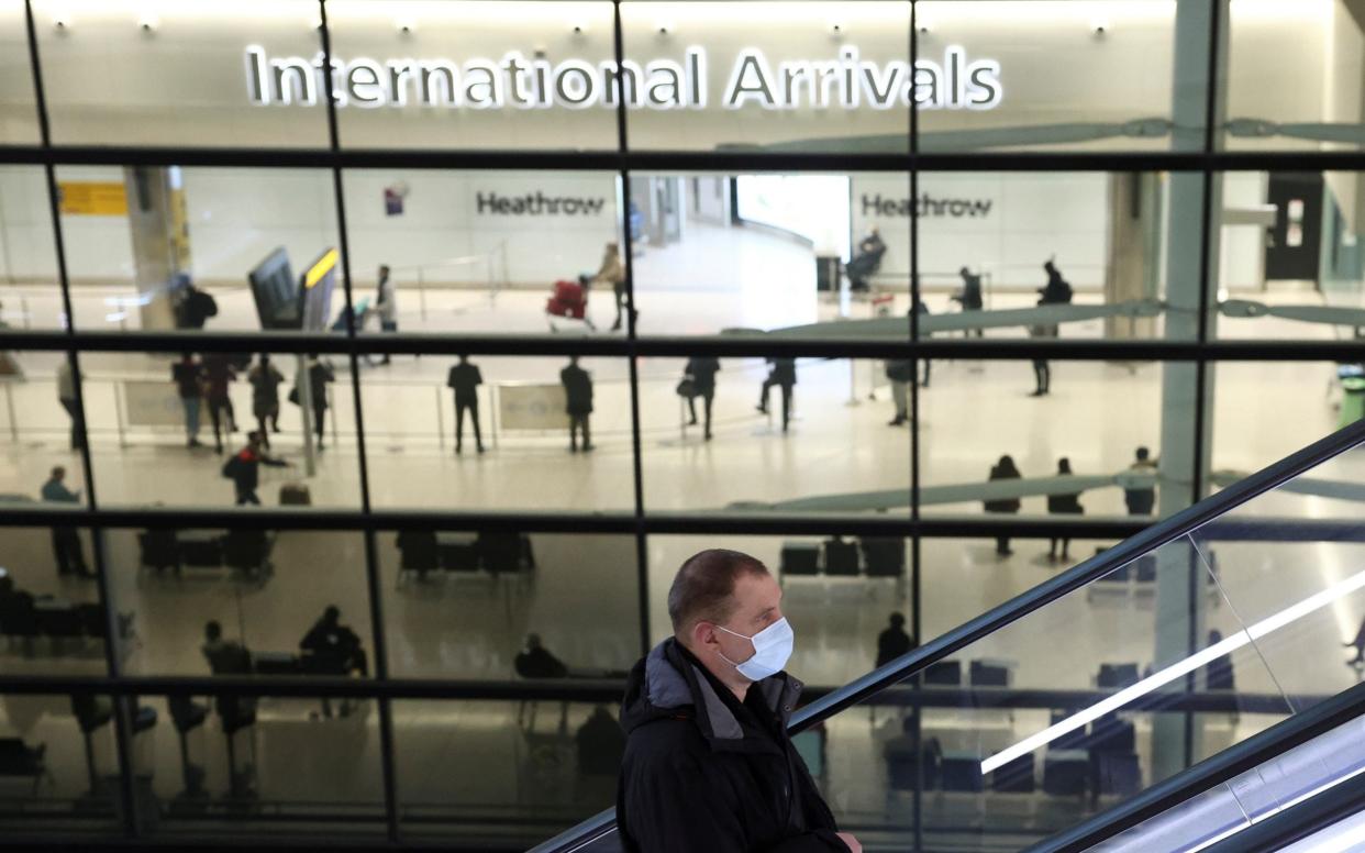 A person goes up an escalator at Terminal 2 of Heathrow Airport, amid the coronavirus disease (COVID-19) outbreak in London  - HENRY NICHOLLS/REUTERS 