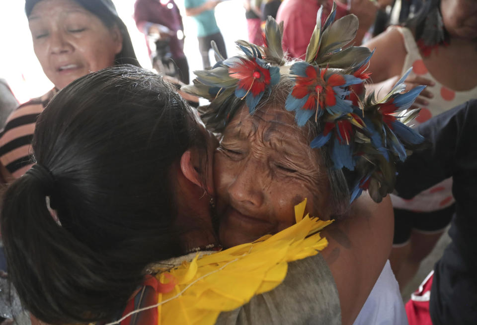 Indigenous women embrace as they celebrate a Supreme Court ruling to enshrine Indigenous land rights, in Brasilia, Brazil, Thursday, Sept. 21, 2023. Six of the 11 Supreme Court justices voted against establishing a cut-off date after which Indigenous peoples could not claim new territory. (AP Photo/Gustavo Moreno)