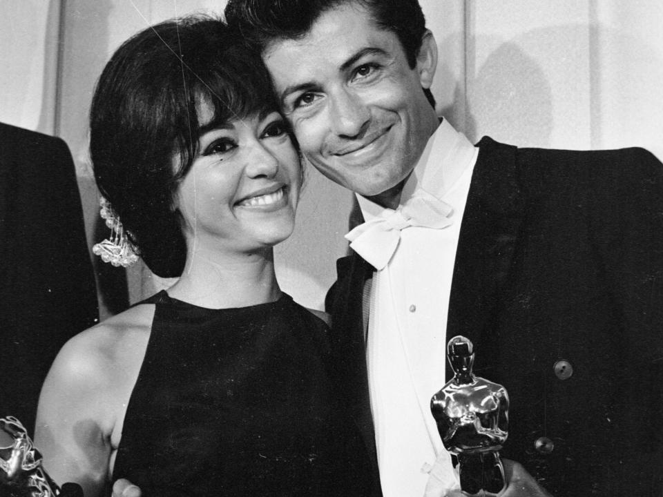Rita Moreno and George Charkis hold their OscarsGetty Images