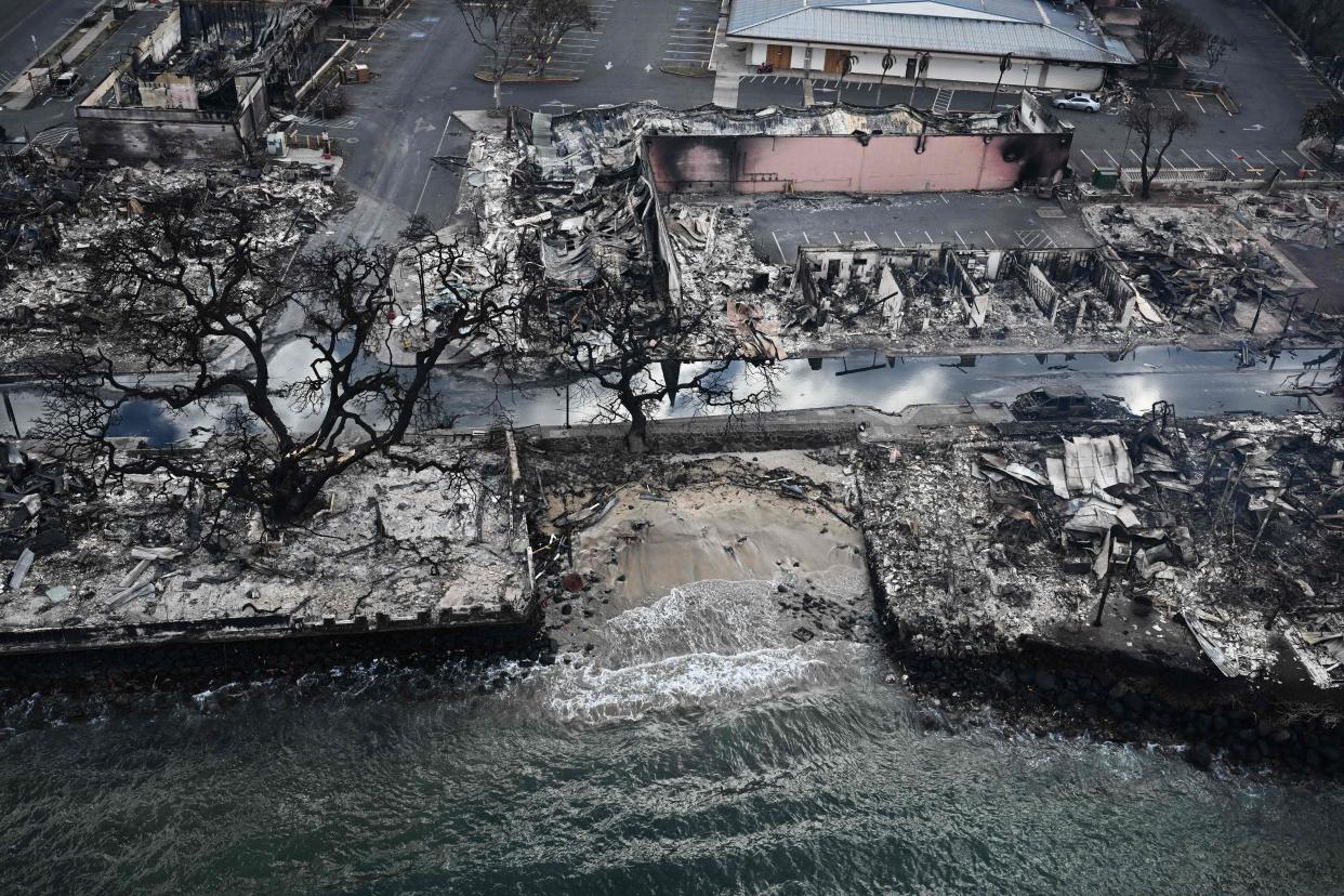 TOPSHOT - An aerial image taken on August 10, 2023 shows destroyed homes and buildings on the waterfront burned to the ground in Lahaina in the aftermath of wildfires in western Maui, Hawaii. At least 36 people have died after a fast-moving wildfire turned Lahaina to ashes, officials said August 9, 2023 as visitors asked to leave the island of Maui found themselves stranded at the airport. The fires began burning early August 8, scorching thousands of acres and putting homes, businesses and 35,000 lives at risk on Maui, the Hawaii Emergency Management Agency said in a statement. (Photo by Patrick T. Fallon / AFP) (Photo by PATRICK T. FALLON/AFP via Getty Images) ORIG FILE ID: AFP_33QU6FM.jpg