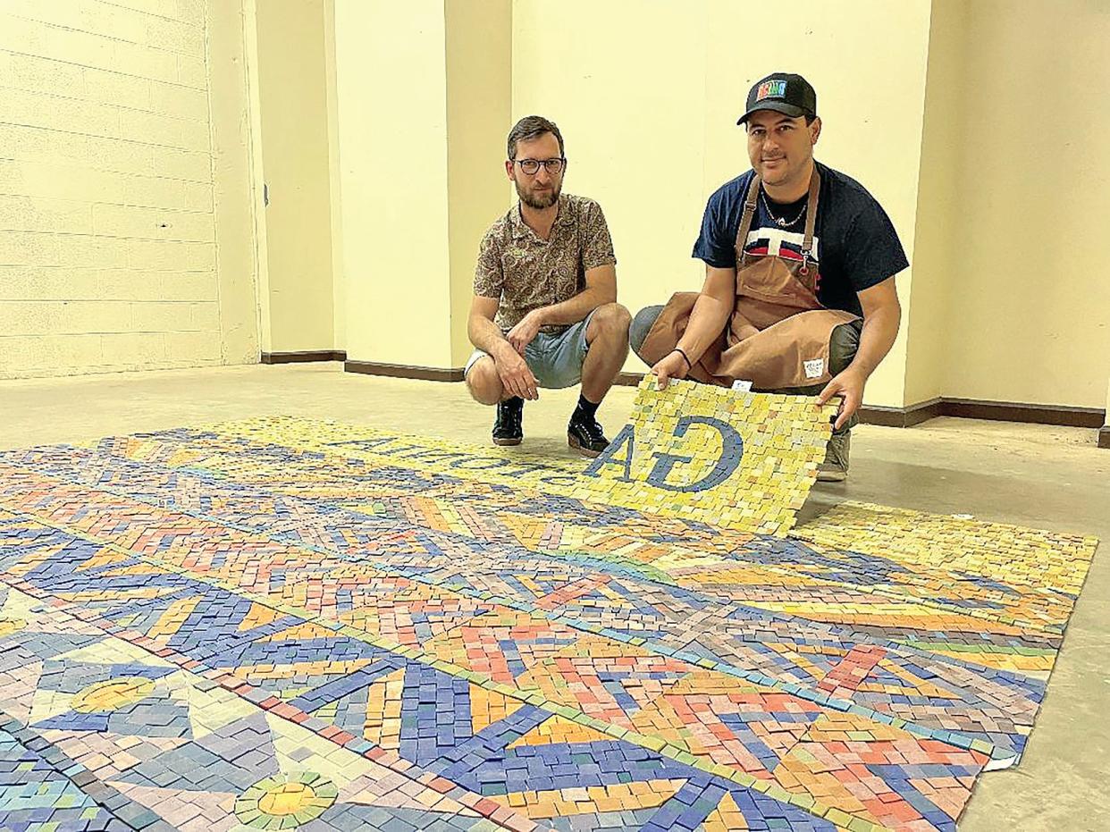 Carlos Gonzalez Garcia, right, with Matko Kezele have been working on a large mosaic to be installed at the ballpark for the minor league baseball team in Gastonia, the Honey Hunters. Garcia said the project should be finished by late July or early August.