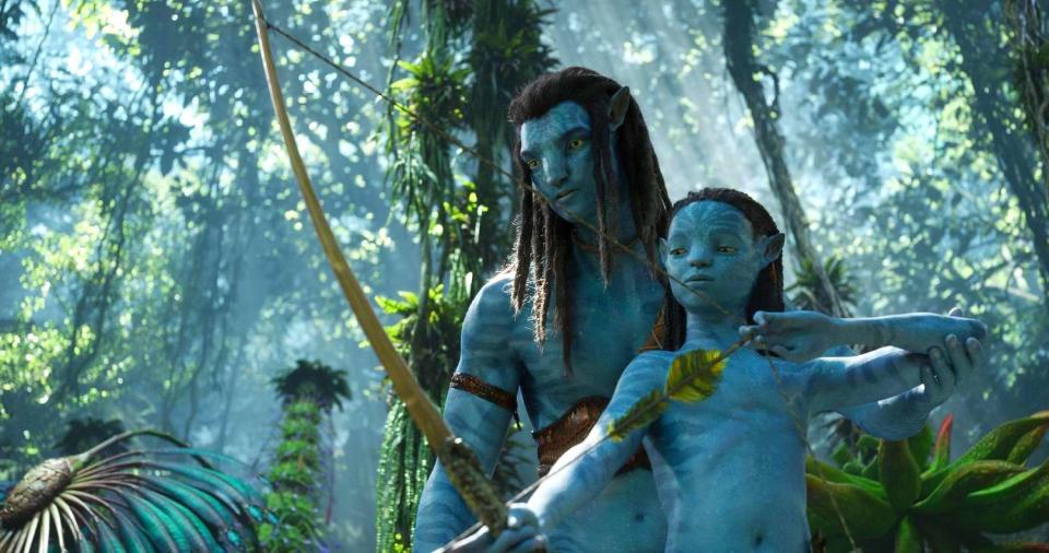 Jake Sully (Sam Worthington) teaches his young Na'vi son in 'Avatar: The Way of Water.'