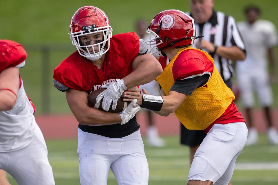 St. John's Logan Mercer takes a hand off from Charlie Giracca versus Brockton in a scrimmage on Saturday August 26th, 2023 in Shrewsbury.