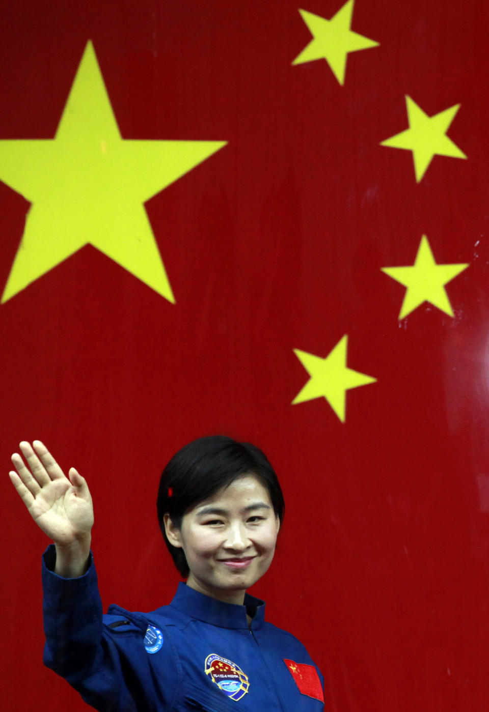 FILE - In this file photo taken Friday, June 15, 2012, Liu Yang, China's first woman astronaut waves as she leaves after attending a meet the press event at the Jiuquan satellite launch center near Jiuquan in western China's Gansu province. A glance at history suggests it's easier for a Chinese woman to orbit Earth than to land a spot on the highest rung of Chinese politics. In June, the 33-year-old Air Force major marked a major feminist milestone by becoming the first Chinese woman to travel in space. With a once-a-decade leadership transition set to kick off Nov. 8, many now are waiting to see if another ambitious Chinese female, State Councilor Liu Yandong, can win one of the nine spots at the apex of Chinese power.(AP Photo/Ng Han Guan, File)