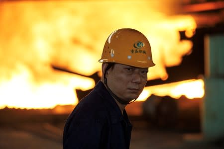 FILE PHOTO: Worker looks on in front of a blast furnace at the Chongqing Iron and Steel plant in Changshou