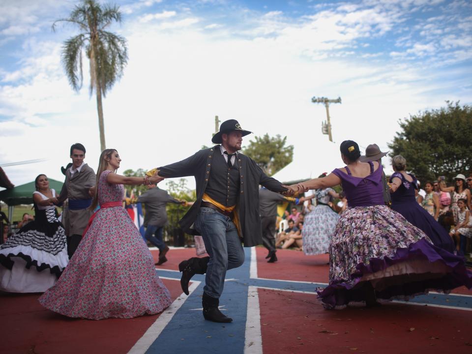 People dance on a Confederate flag