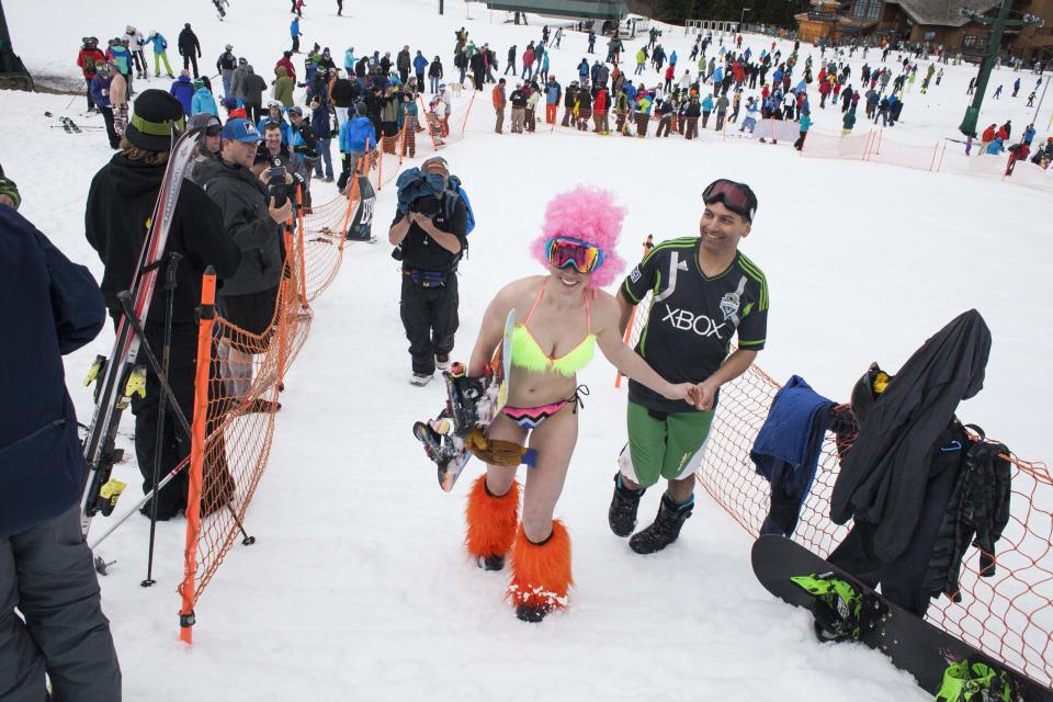 Claire McGuire (C) smiles after winning the women's snowboard division of the Bikini & Board Shorts Downhill at Crystal Mountain, a ski resort near Enumclaw, Washington April 19, 2014. Skiers and snowboarders competed for a chance to win one of four season's passes. REUTERS/David Ryder (UNITED STATES - Tags: SPORT SOCIETY)