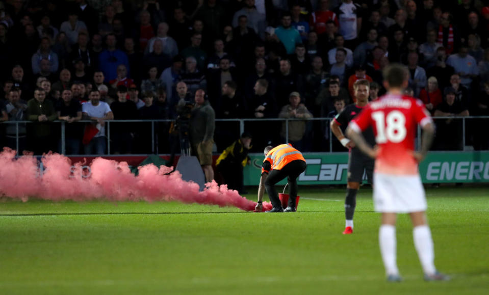 A flare thrown onto the pitch during Salford v Leeds (Martin Rickett/PA Wire)