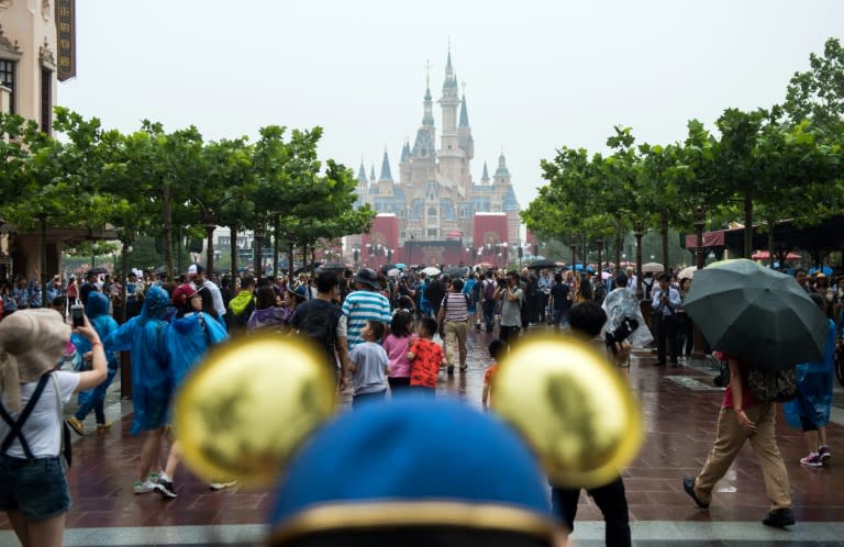 Visitors enter the Shanghai Disney theme park after the opening ceremony on June 16, 2016