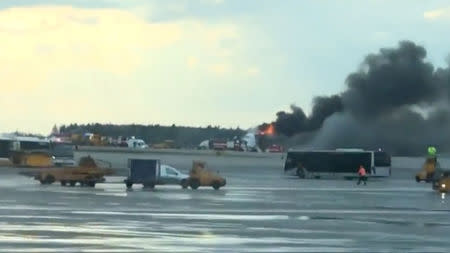 Smoke billows from a Sukhoi passenger plane after it made an emergency landing due to an onboard fire at Sheremetyevo International Airport, outside Moscow, Russia May 5, 2019. Twitter @Justin Goslin via REUTERS