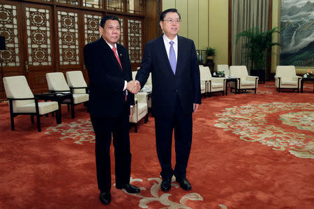 Philippines President Rodrigo Duterte (L) shakes hands with Zhang Dejiang, Chairman of the Standing Committee of the National People's Congress of China ahead of a meeting at the Great Hall of the People in Beijing, China, October 20 2016. REUTERS/Wu Hong/Pool