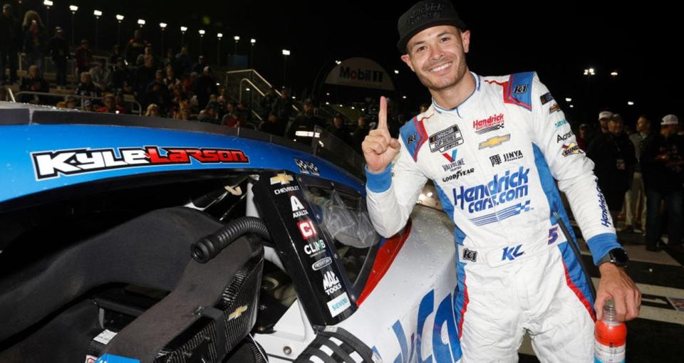 KANSAS CITY, KANSAS - MAY 05: Kyle Larson, driver of the #5 HendrickCars.com Chevrolet, poses with the winner sticker on his car in victory lane after winning the NASCAR Cup Series AdventHealth 400 at Kansas Speedway on May 05, 2024 in Kansas City, Kansas. (Photo by Sean Gardner/Getty Images)