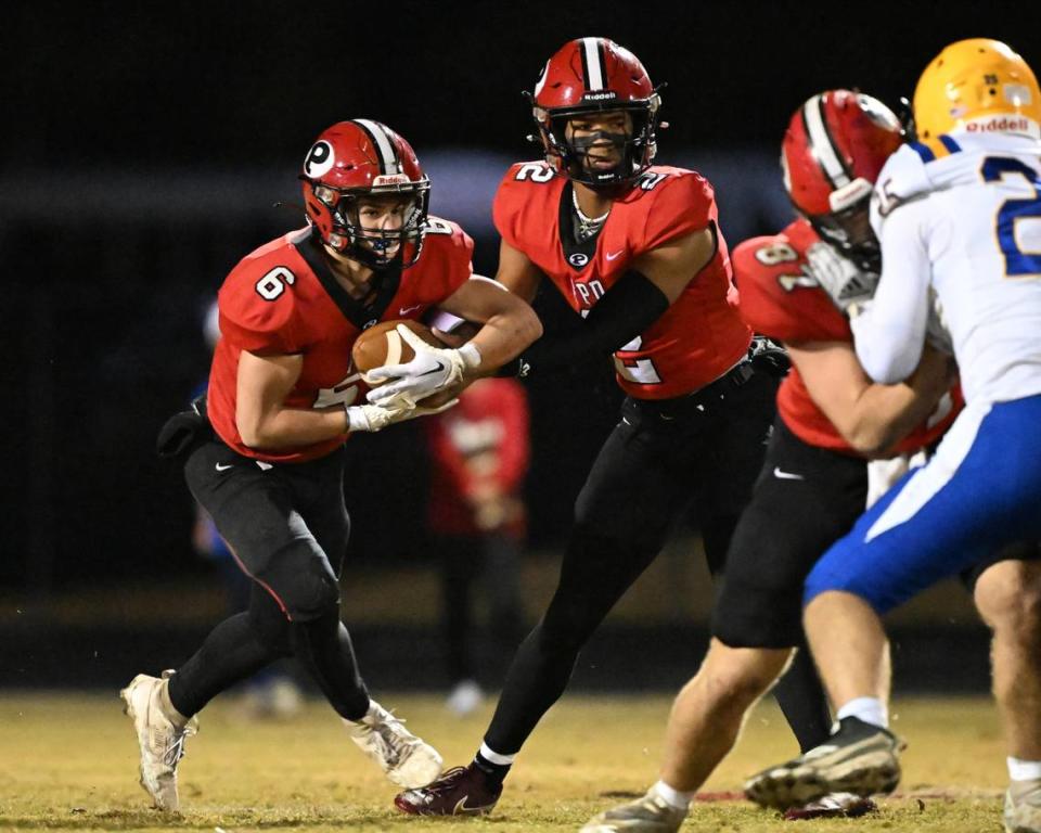 FPD quarterback Jakhari Williams (2) hands off the ball to running back Hayden Aulds (6) Friday night against Tattnall.