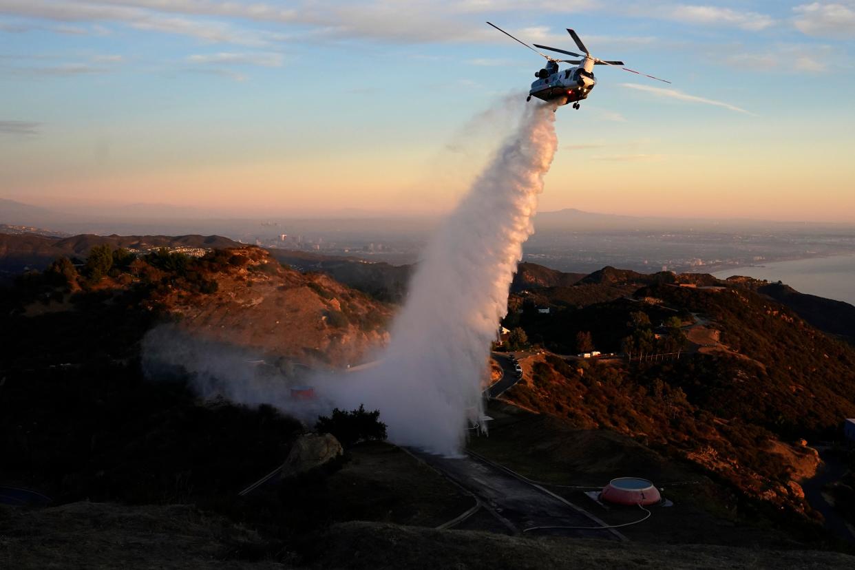 <p>A Chinook CH-47 helitanker makes a water drop in the Santa Monica Mountains west of Los Angeles</p> ((Associated Press))