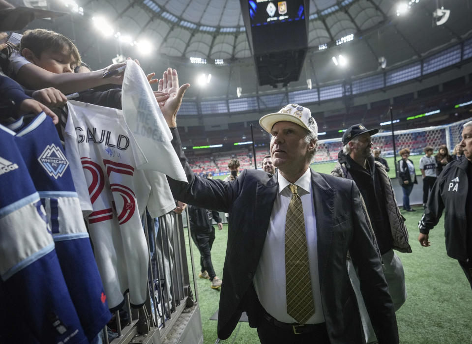 Los Angeles FC co-owner, comedian and actor Will Ferrell, center, greets Vancouver Whitecaps fans as he leaves the field before Game 2 of a first-round MLS playoff soccer match in Vancouver, British Columbia, Sunday, Nov. 5, 2023. (Darryl Dyck/The Canadian Press via AP)