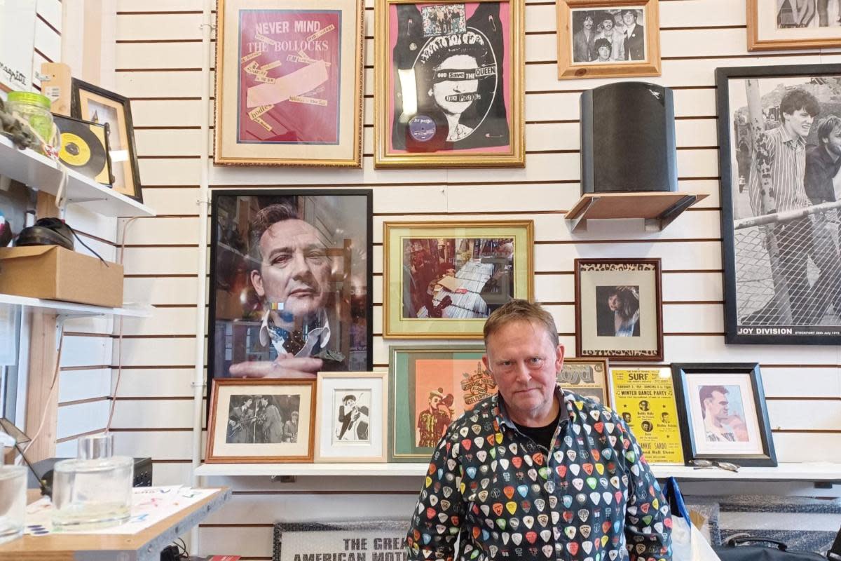 Mark James stood in front of the wall with the framed picture (Image: Newsquest) <i>(Image: Newsquest)</i>