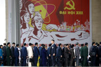 Delegates arrive at the national convention center to attend the 13th Communist Party Congress in Hanoi, Vietnam Tuesday, Jan. 26, 2021. Vietnam's ruling Communist Party has begun a crucial weeklong meeting in the capital Hanoi to set the nation's path for the next five years and appoint the country's top leaders. (AP Photo/Minh Hoang)