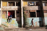 <p>Residents are shown outside a set of buildings in the Mangueira favela in Rio de Janeiro, May 4, 2017. (Photo: Mario Tama/Getty Images) </p>