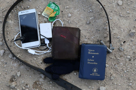 The possessions of an immigrant who illegally crossed the border from Mexico into the U.S. lay on the ground following an apprehension in the Rio Grande Valley sector, near McAllen, Texas, U.S., April 3, 2018. REUTERS/Loren Elliott