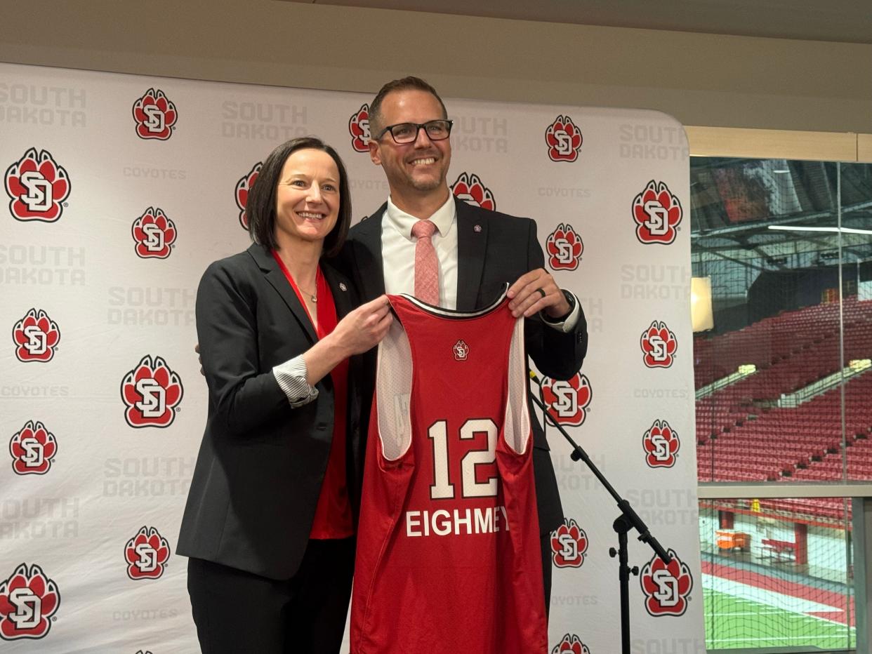 University of South Dakota athletic director Jon Schemmel (right) introduces Carrie Eighmey (left), the 12th women's basketball head coach in program history on Tuesday, May 7th.