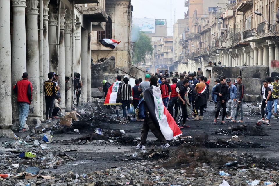 Anti-government protesters gather while security forces close Rasheed Street, in Baghdad, Iraq, Sunday, Dec. 1, 2019. Iraq’s parliament approved the resignation of Prime Minister Adel Abdul-Mahdi, amid ongoing violence and anti-government demonstrations in the capital. (AP Photo/Khalid Mohammed)