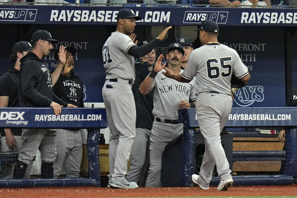 New York Yankees starting pitcher Nestor Cortes (65) celebrates with teammates after being taken out of the game against the Tampa Bay Rays during the ninth inning of a baseball game Thursday, May 26, 2022, in St. Petersburg, Fla. (AP Photo/Chris O'Meara)