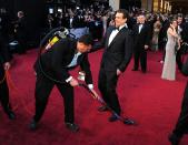 <p>After Sacha Baron Cohen's stunt, someone swooped in to clean up—clearly unaware they were in the presence of (and blocking) the hilarious <em>How I Met Your Mother</em> star.</p>