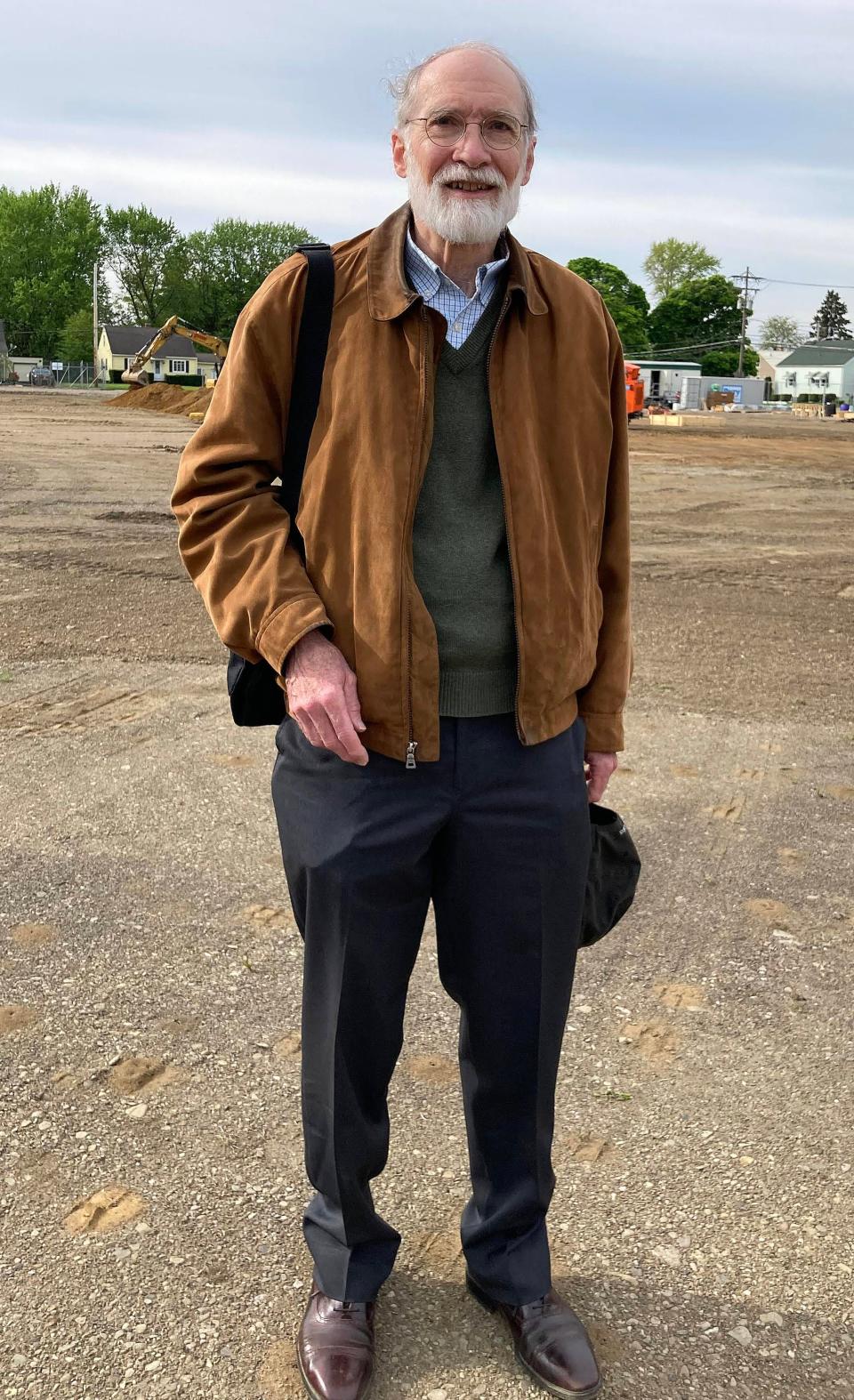 Richard Obermanns, 77, of Shaker Heights, Ohio, near Cleveland, was in first grade at Erie's Edison Elementary School in 1952, when the school completed its last major renovation. He attended the groundbreaking for the new Edison Elementary School on Monday. Behind him is the lot where the new Edison is going up, just south of the existing school on East Lake Road.