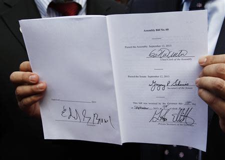 A copy of the "AB60" that California Governor Jerry Brown (unseen) signed into law is seen after ceremonies in Los Angeles October 3, 2013. REUTERS/Fred Prouser