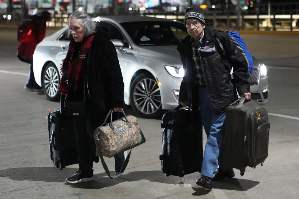 Travelers walk to a ticketing desk at the O'Hare International Airport in Chicago, Thursday, Dec. 21, 2023. It's beginning to look a lot like a hectic holiday travel season, but it might go relatively smoothly if the weather cooperates. (AP Photo/Nam Y. Huh)