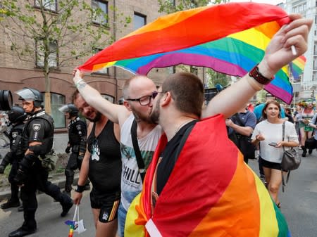 Participants kiss as they attend the Equality March, organized by the LGBT community in Kiev