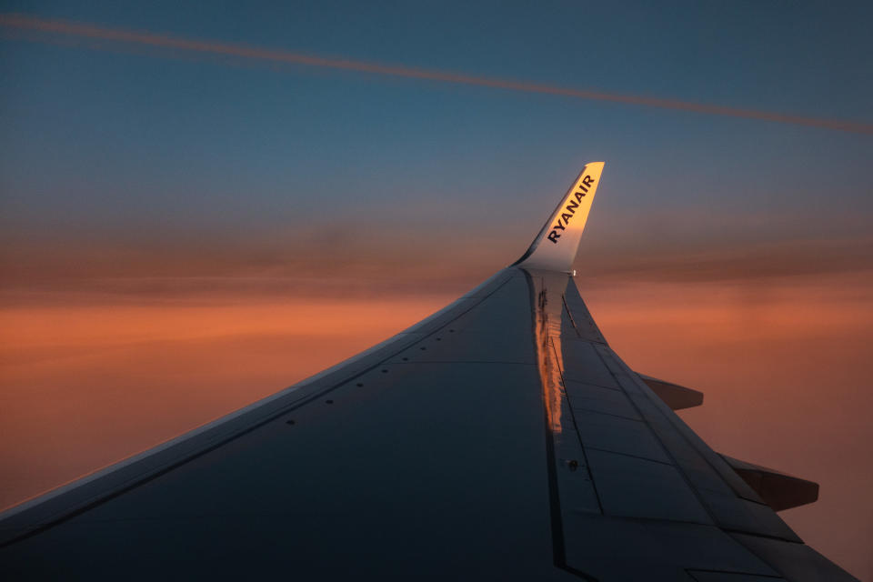 Wing view from the window of an airliner during the magic hour after the sunset. The aircraft is a Boeing 737-800 of the low-cost airline, Ryanair. (Photo by Nicolas Economou/NurPhoto via Getty Images)