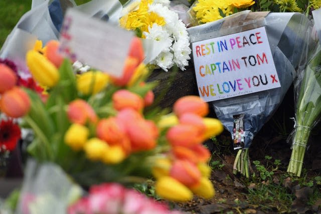 Floral tributes outside the home of Captain Sir Tom Moore in Marston Moretaine, Bedfordshire. The 100-year-old charity fundraiser died on Tuesday after testing positive for Covid-19 