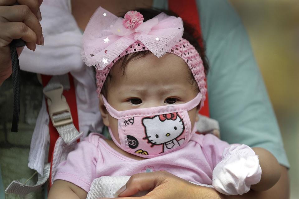 A baby wears a Hello Kitty face mask in Manila.
