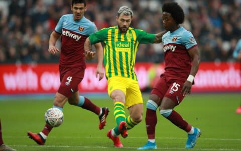 West Bromwich Albion's Charlie Austin in action with West Ham United's Carlos Sanchez - Credit: Reuters