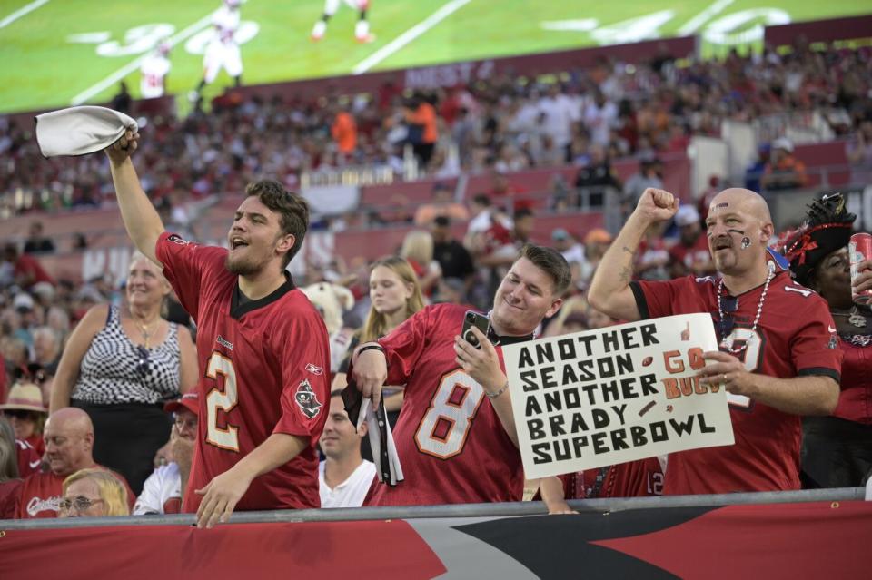 Tampa Bay Buccaneers fans cheer in the stands during the first half of a preseason NFL football game