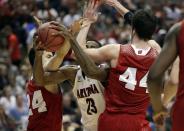 Arizona's Rondae Hollis-Jefferson tries to drive between Wisconsin 's Bronson Koenig (24) and Frank Kaminsky (44) during the second half in a regional final NCAA college basketball tournament game, Saturday, March 29, 2014, in Anaheim, Calif. (AP Photo/Jae C. Hong)