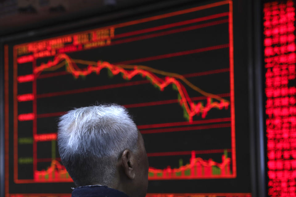 An investor monitors stock prices in Beijing, China, Friday, Nov. 16, 2018. Shares were mixed in early trading in Asia on Friday on revived concerns over the prospects for a breakthrough in trade tensions between the U.S. and China. (AP Photo/Ng Han Guan)
