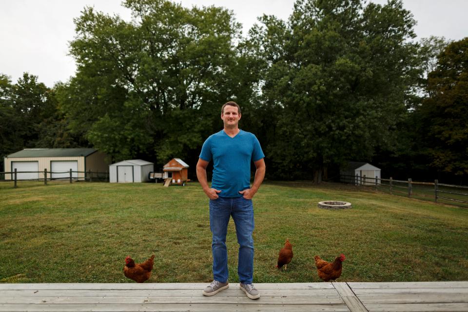 Brad Horn poses on the porch at his home in Cleves, Ohio, on Wednesday, Sept. 23, 2020. Horn was laid off from his job with GE Aviation in the spring with no expected return date. 