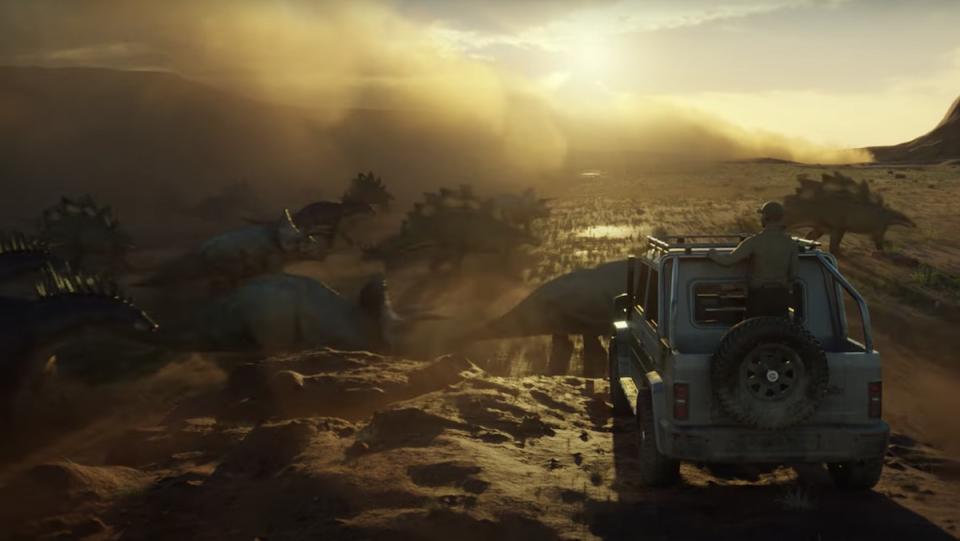 A video game rendering of a man in a truck looking out over a cliff watching triceratops run in a cloud of dust