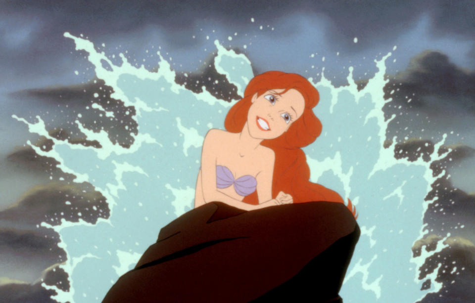 A mermaid sings on a rock