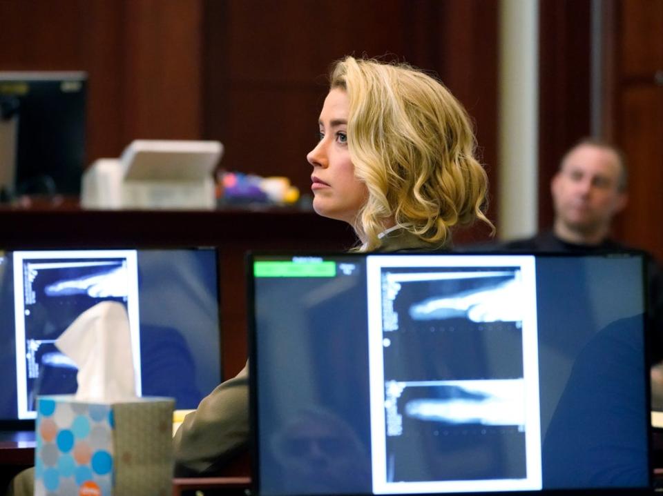 Actor Amber Heard listens in the courtroom at the Fairfax County Circuit Courthouse in Fairfax, Virginia, USA, 23 May 2022 (EPA)