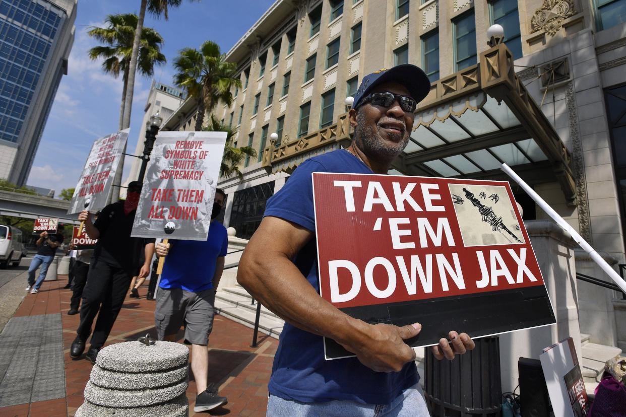 Maceo George takes part in the weekly Friday picket line in front of Jacksonville City Hall that demands the removal of Confederate monuments from city parks.