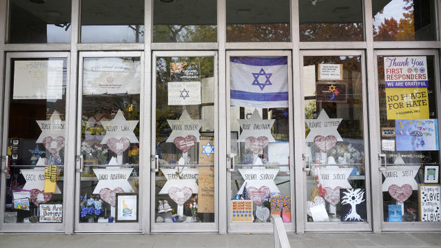 FILE - A memorial is placed inside the locked doors of the dormant landmark Tree of Life synagogue in Pittsburgh's Squirrel Hill neighborhood on Wednesday, Oct. 26, 2022. The head of security for Pittsburgh's Jewish community said Friday, May 12, 2023, there has been an “uptick in hate speech” on the internet, but no specific threats, in the early stages of the trial of the man accused of killing 11 worshippers at a synagogue here in 2018. (AP Photo/Gene J. Puskar, File)