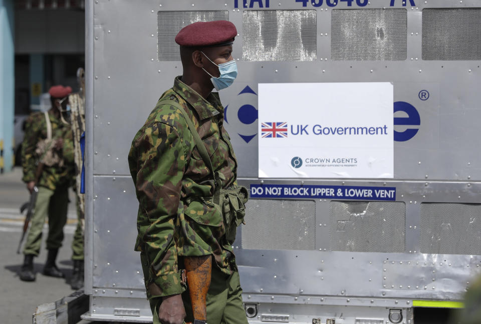 FILE - In this July 31, 2021, file photo, Kenyan soldiers guard the 410,000 doses of COVID-19 vaccines donated by the United Kingdom Government at the Jomo Kenyatta International Airport, Nairobi, Kenya. Authorities in India and some African countries are furious over the U.K.'s new COVID-19 travel rules. People vaccinated in many countries, including Kenya, still have to quarantine upon arrival in England. (AP Photo/Brian Inganga, File)