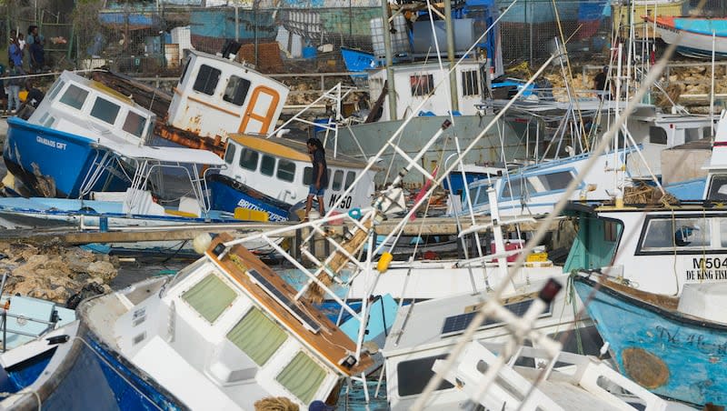 A fisherman looks at fishing vessels damaged by Hurricane Beryl at the Bridgetown Fisheries in Barbados, Monday, July 1, 2024. Hurricane Beryl caused damage across the Caribbean islands and killed four people on Monday and is now a Category 5 hurricane.