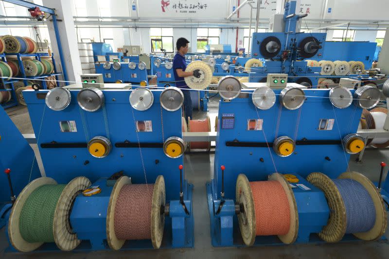 FILE PHOTO: Employee works at a factory of the Zhejiang Headway Communication Equipment Co in Huzhou