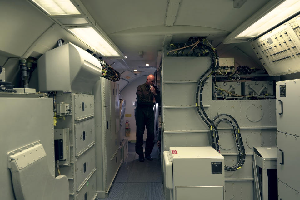 The commander of France's AWACS squadron, a lieutenant colonel named Richard, talks to crew members aboard one of the four French surveillance planes as it flies a 10-hour mission Tuesday, Jan. 9, 2024, to eastern Romania for the NATO military alliance. Because of French security concerns, The Associated Press was only able to identify him and other military personnel aboard the flight by their ranks and first names. Lt. Col. Richard said the powerful radars aboard AWACS surveillance planes give them a "God's eye view." (AP Photo/John Leicester)